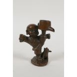 A Japanese bronze okimono in the form of a child practising martial arts, 3" high