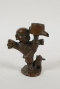 A Japanese bronze okimono in the form of a child practising martial arts, 3" high