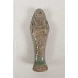 An Egyptian turquoise glazed faience pottery shabti, 4" high