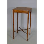 A mid C20th bespoke yew wood lamp table, raised on slender tapering supports united by shaped
