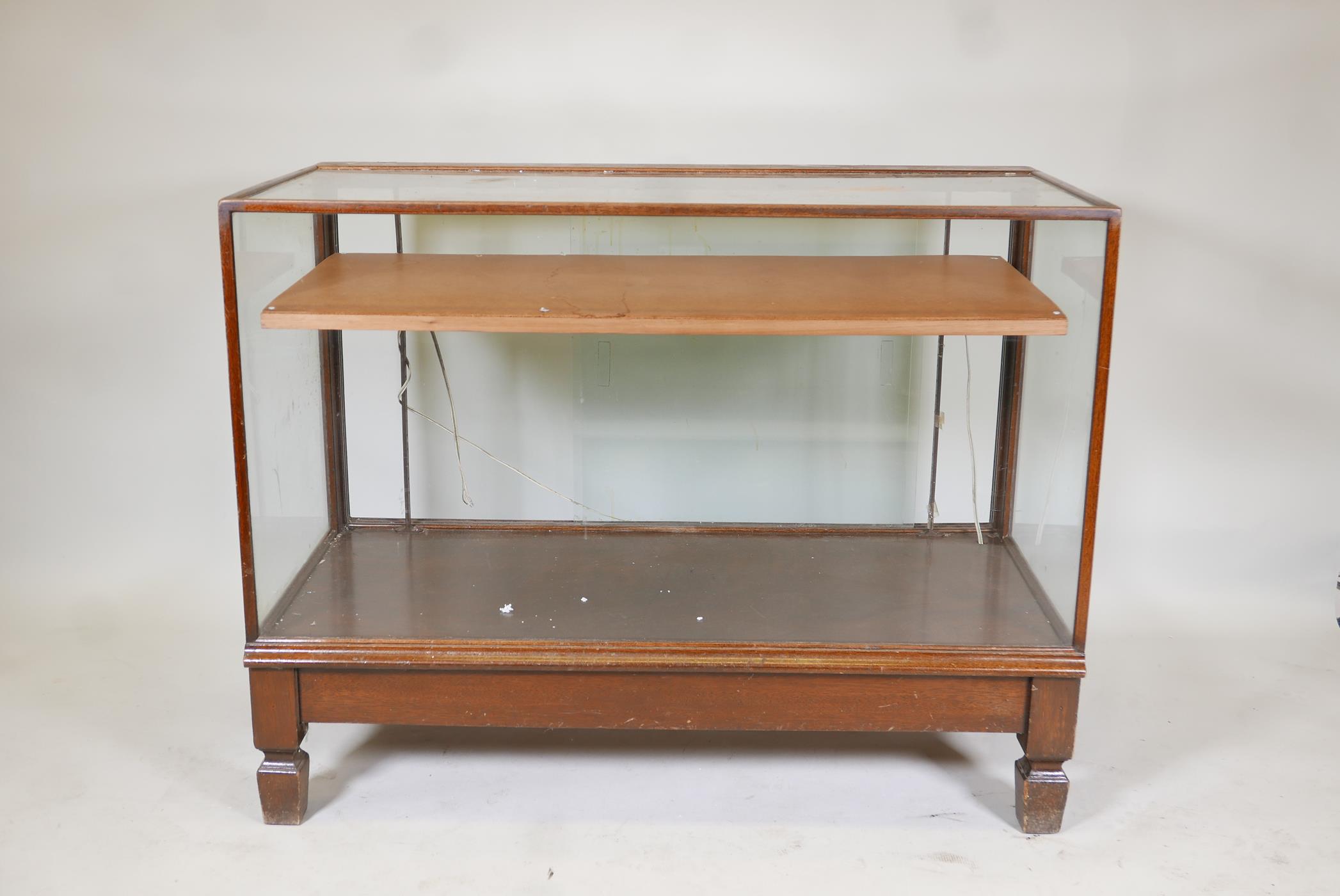 Antique mahogany glass top shop display cabinet, illuminated,  raised on square supports, with