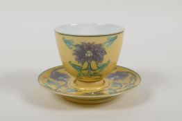 A Chinese Sancai glazed porcelain tea cup and saucer with lotus flower decoration, Kangxi 6