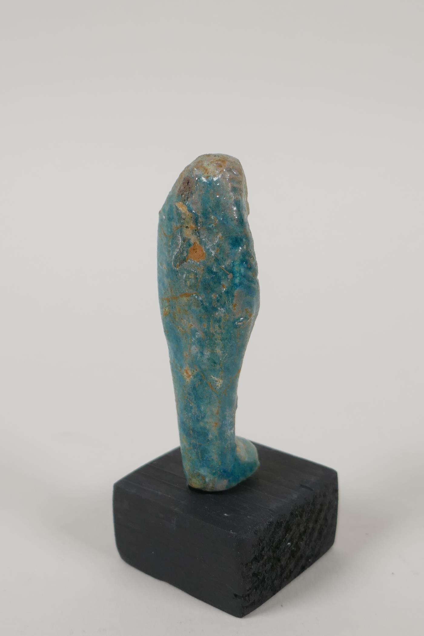 An Egyptian turquoise glazed faience shabti, a turquoise glazed pottery token in the form of the Eye - Image 3 of 6