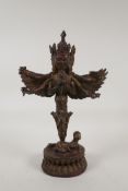 A Sino Tibetan bronze phurba ornament in the form of a winged and many armed wrathful deity, with