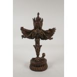 A Sino Tibetan bronze phurba ornament in the form of a winged and many armed wrathful deity, with