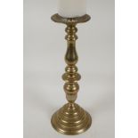 An ecclesiastical turned brass pricket candlestick, 15" high
