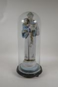 An early C20th painted plaster figure of a saint and child, with gilt highlights, A/F, in a glass