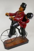A composition figure of Laurel and Hardy riding a penny farthing bicycle, 23½" high