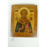 An C18th Russian Orthodox icon of Saint Nicholas, painted on a poplar panel and fitted with a silver