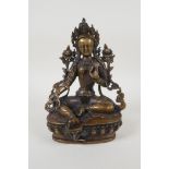 A Sino Tibetan bronze figure of a deity seated on a lotus throne, 8" high