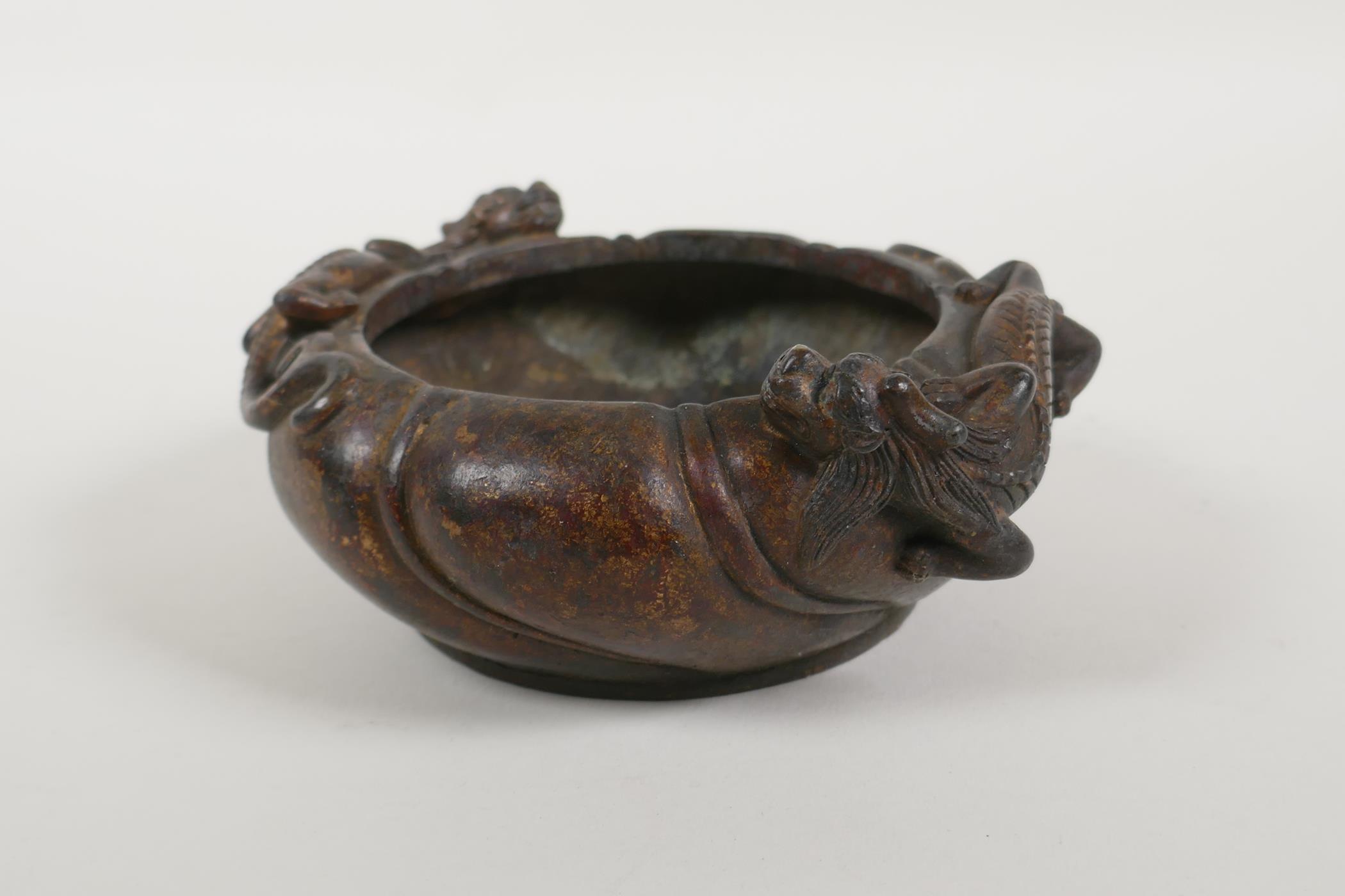 A Chinese gilt bronze censer of lobed form, with raised twin dragon decoration, impressed mark to - Image 3 of 4