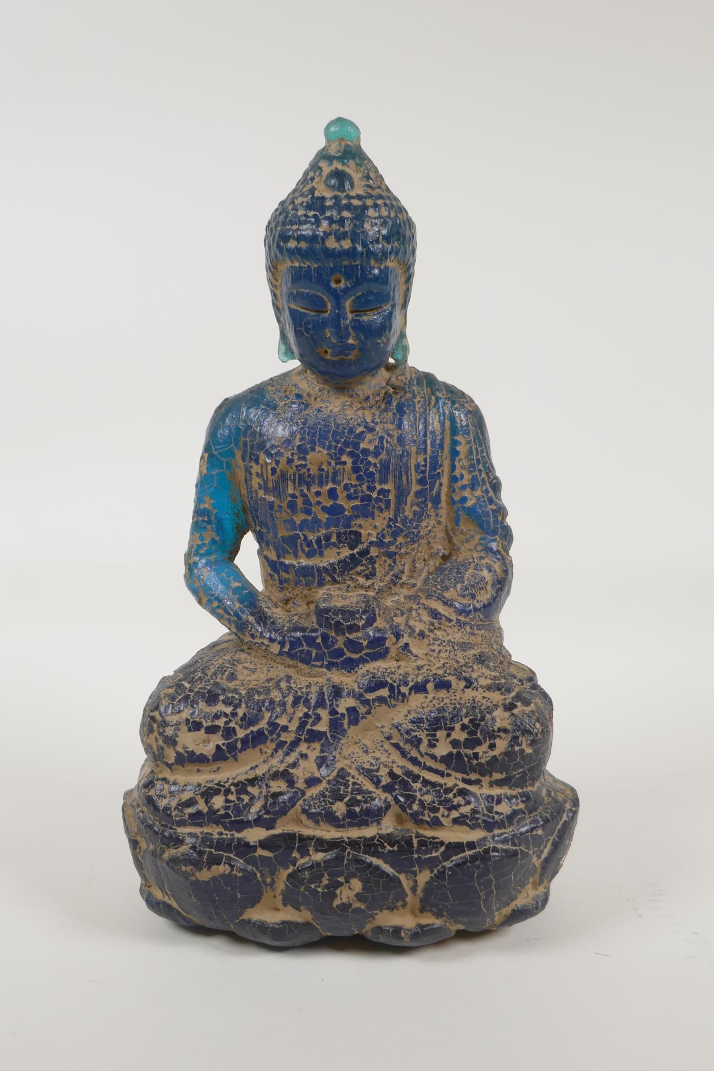 A Chinese archaic style blue composition figure of buddha with a distressed finish, 10" high