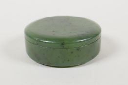 A mottled green jade ink box and cover, 2" diameter