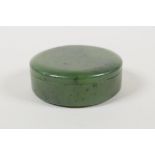 A mottled green jade ink box and cover, 2" diameter