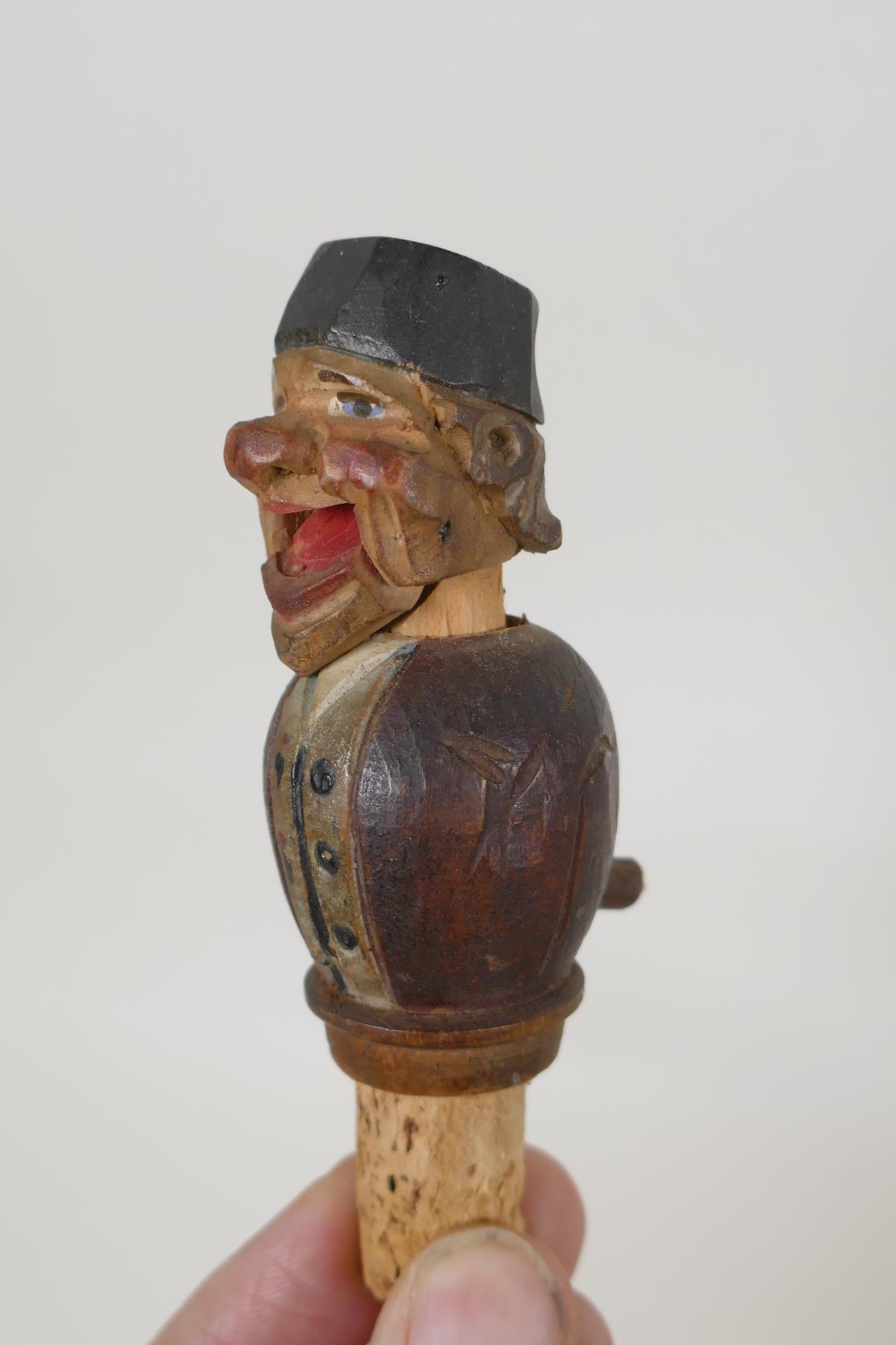 A set of four carved and painted Black Forest figural caricature bottle stoppers/pourers, in a - Image 2 of 7