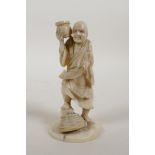 A Japanese Meiji period ivory okimono figure carrying a scroll, signed in red cartouche to the base,