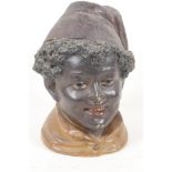 A Bohemian pottery tobacco jar moulded in the form of a boy's head, 'The Magician' by Bernard Bloch,