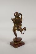 An oriental filled bronze of a skeletal scribe, with gilt patina, 8½" high