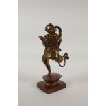 An oriental filled bronze of a skeletal scribe, with gilt patina, 8½" high