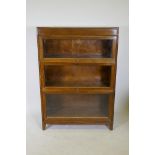 An early C20th American oak three section Globe Wernicke  style bookcase by Gunn Furniture of