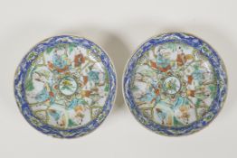 A pair of Chinese polychrome porcelain saucers decorated with the eight immortals, 4½" diameter