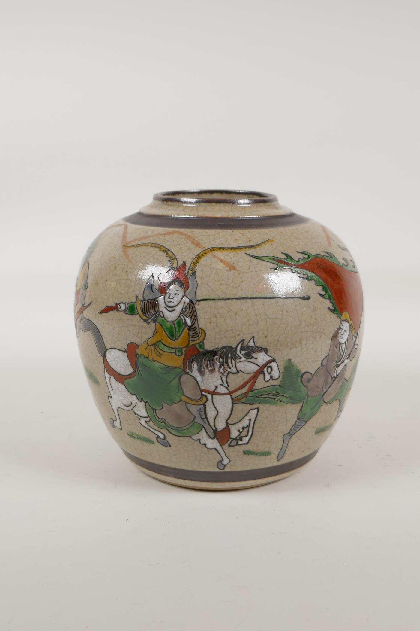 A Chinese crackleware jar with polychrome enamelled decoration of warriors, carved 4 character