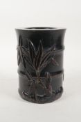 An oriental ebonised hardwood brush pot with carved bamboo and insect decoration, 6" high x 4½"