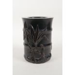 An oriental ebonised hardwood brush pot with carved bamboo and insect decoration, 6" high x 4½"