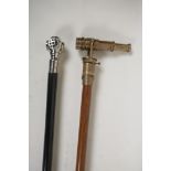 An ebonised wood walking stick with a plated handle in the form of a diver's helmet, and a brass