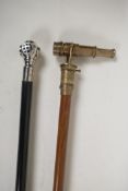 An ebonised wood walking stick with a plated handle in the form of a diver's helmet, and a brass
