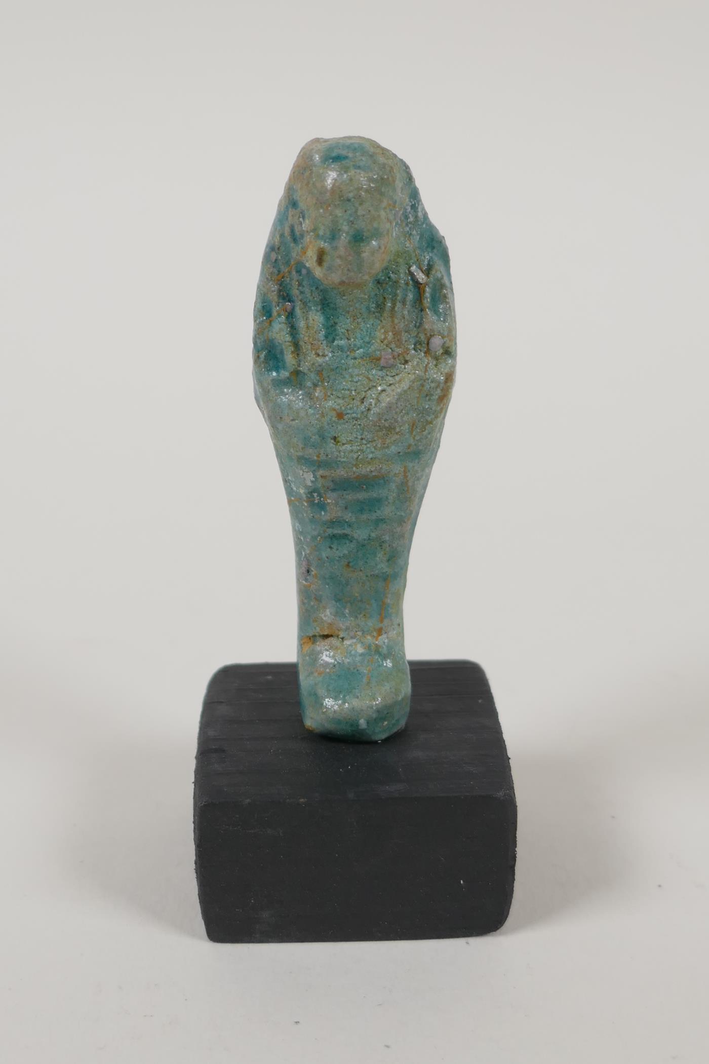 An Egyptian turquoise glazed faience shabti, a turquoise glazed pottery token in the form of the Eye - Image 2 of 6