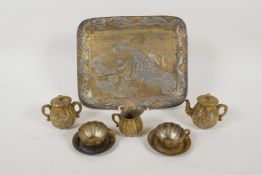 A miniature Japanese Antimony tea set with raised decoration of peacocks, dragons and birds