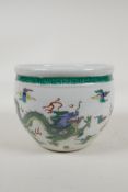 A Chinese famille vert porcelain jardiniere decorated with dragons chasing the flaming pearl, leaf
