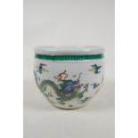 A Chinese famille vert porcelain jardiniere decorated with dragons chasing the flaming pearl, leaf