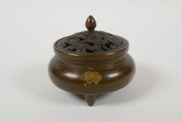 A Chinese gilt splash bronze censer and cover on tripod supports, with a pierced lid, 6 character