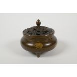 A Chinese gilt splash bronze censer and cover on tripod supports, with a pierced lid, 6 character
