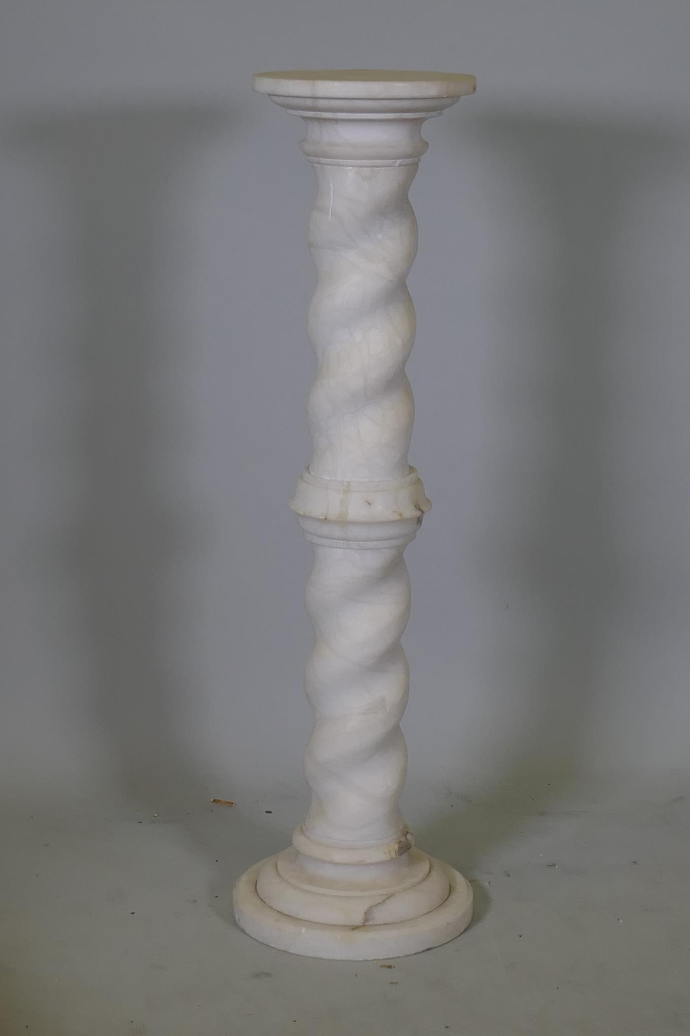 An alabaster jardiniere stand with barley twist column, 39" high