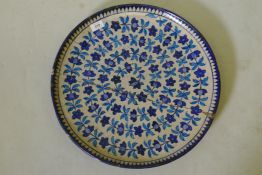 Antique middle Eastern glazed terracotta charger with Iznik style decoration, A/F, 18" diameter
