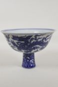 A Chinese blue and white porcelain stem bowl decorated with two dragons, 6 character mark to the