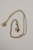A 9ct gold chain and pendant set with a sapphire, chain 15" long