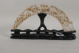 A C19th Cantonese carved ivory tusk, mounted on a wood base, 12" x 6½"