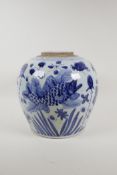 A Chinese blue and white porcelain ginger/storage jar decorated with carp in a lotus pond, lacks