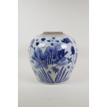 A Chinese blue and white porcelain ginger/storage jar decorated with carp in a lotus pond, lacks