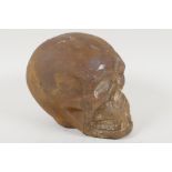 A cast iron skull, 6" high