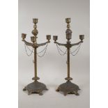 A pair of gilt metal three branch candlesticks of classical form, 17" high