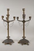 A pair of gilt metal three branch candlesticks of classical form, 17" high