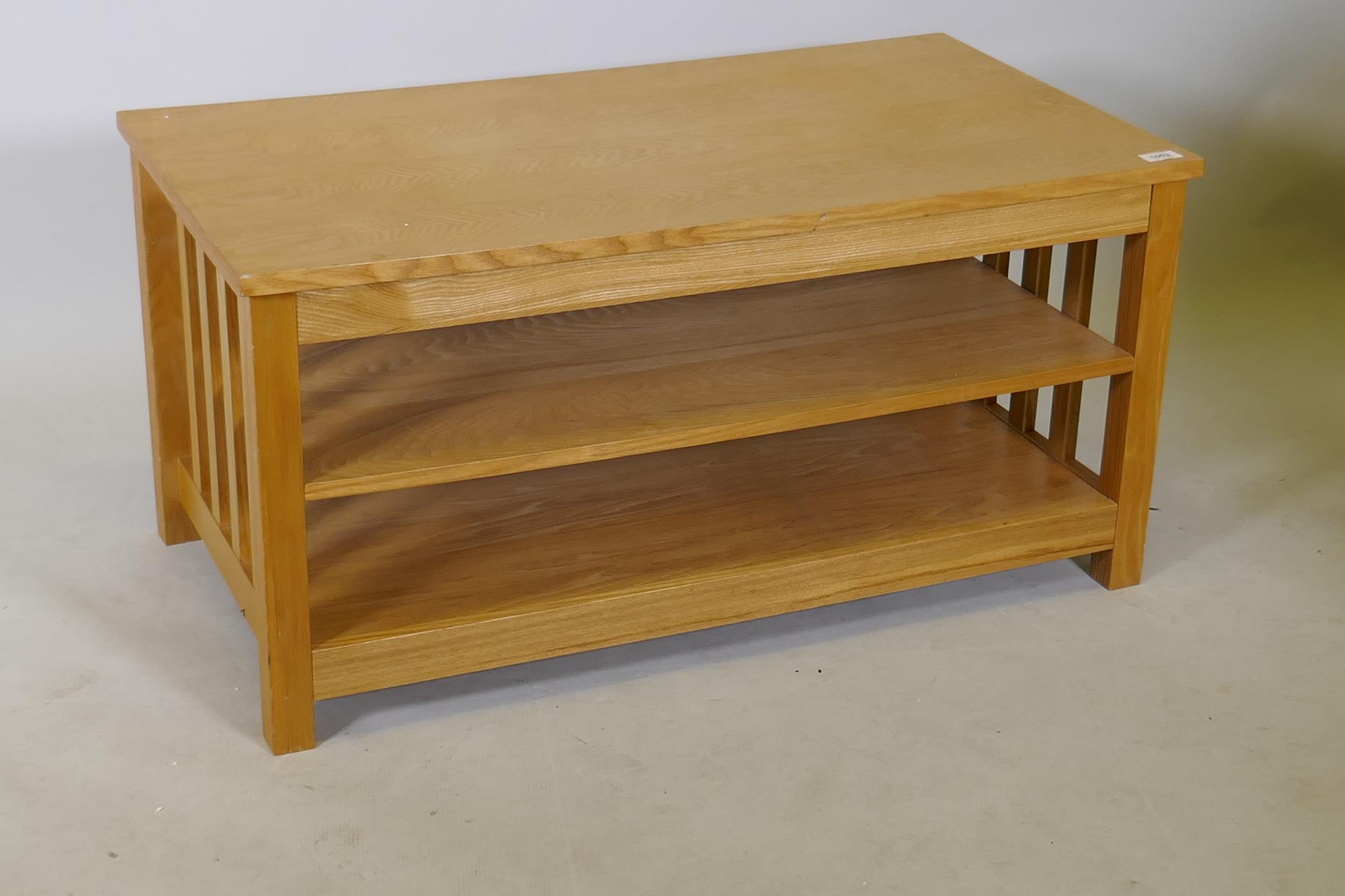 A contemporary light oak three tier coffee table with slatted ends, 20" x 36" x 18"