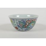 A Doucai porcelain tea bowl with dragon and lotus flower decoration, Chinese 6 character mark to