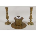 An Art Deco brass capstan inkwell with enamelled cover and a pair of miniature brass candlesticks,