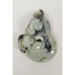 A Chinese celadon jade pendant with black inclusions, and carved kylin decoration, 2½" x 3½"